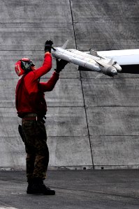 US Navy 110515-N-UO379-061 Lance Cpl. Vincent Johnson erforms a pre-flight inspection of an AIM-9 Sidewinder missile attached to an F-A-18C Hornet