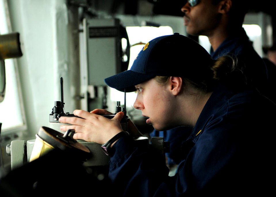 US Navy 110515-N-YM590-102 Ensign Meredith C. Manuel peers through a telescopic alidade on the bridge aboard the guided-missile cruiser USS Anzio (