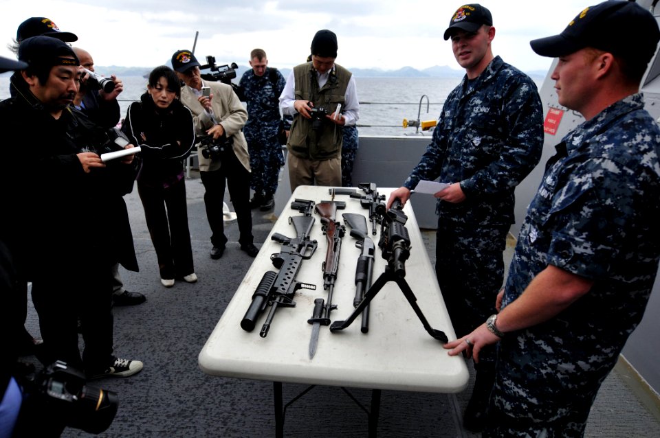 US Navy 110517-N-WW409-196 Gunner's Mate 1st Class Michael Hoar, right, and Gunner's Mate 3rd Class Kaleb Casey Williams show members of the Japane