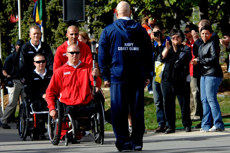 US Navy 110516-N-CD297-037 Logistics Specialist 1st Class Robert Lipscomb waits for the torch during the opening ceremony of the second annual Warr