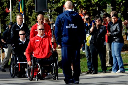 US Navy 110516-N-CD297-037 Logistics Specialist 1st Class Robert Lipscomb waits for the torch during the opening ceremony of the second annual Warr