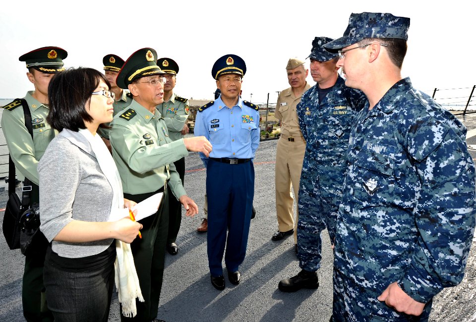 US Navy 110519-N-CI175-102 An officer from the Republic of China People's Liberation Army asks Gunner's Mate 3rd Howard Bullock a question about th