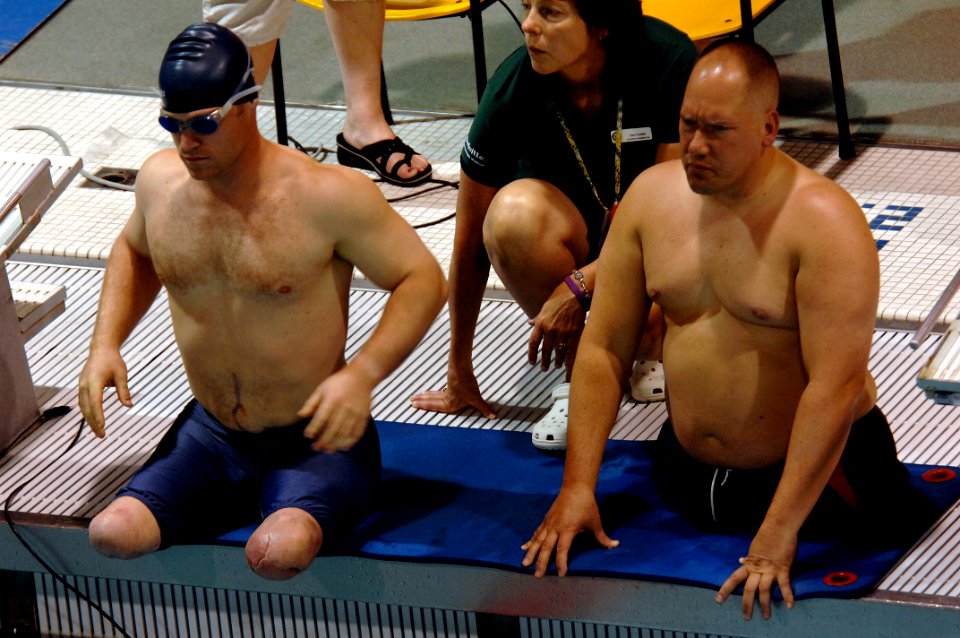 US Navy 110520-N-CD297-064 Lt. Daniel Cnossen, left, waits to swim in the 100-meter Freestyle event as a member of Team Navy-Coast Guard during th
