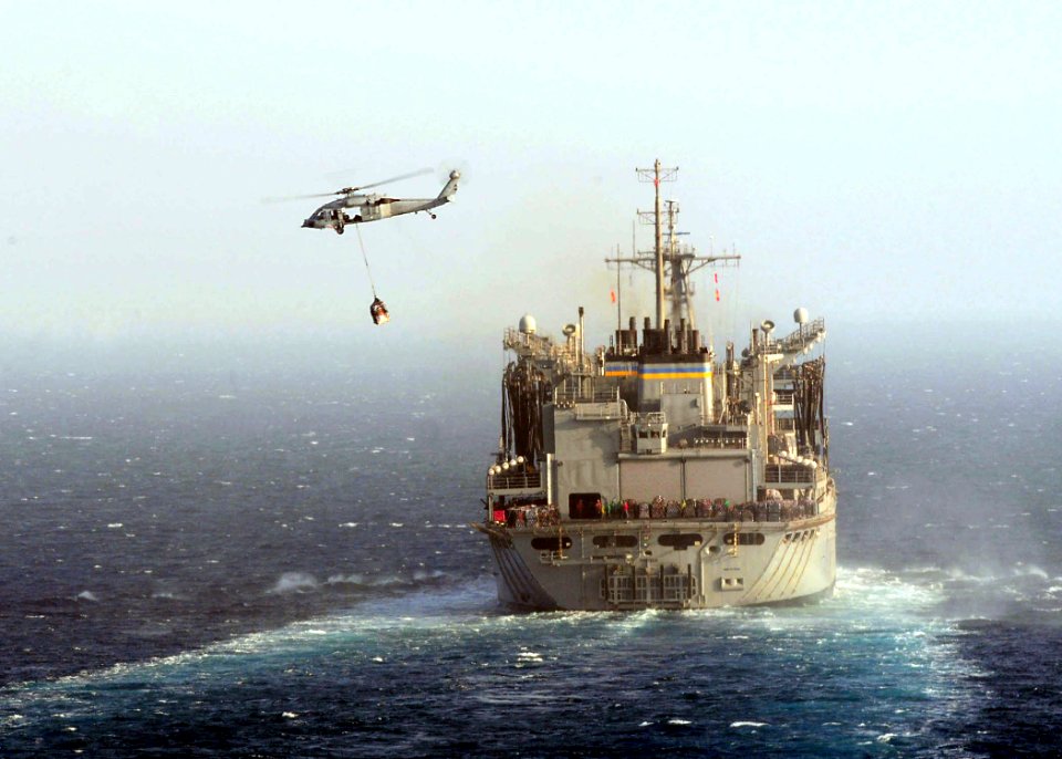 US Navy 110519-N-SG869-153 An SH-60S Sea Hawk helicopter assigned to the Wild Cards of Helicopter Sea Combat Squadron (HSC) 23 transfers pallets fr
