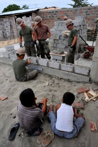 US Navy 110517-F-ET173-200 Ecuadorian boys watch as Seabees assigned to Naval Mobile Construction Battalion (NMCB) 28 and Marines assigned to the 8 photo