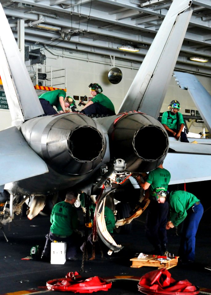 US Navy 110518-N-GL340-085 Sailors assigned to the Argonauts of Strike Fighter Squadron (VFA) 147 perform maintenance on an F-A-18E Super Hornet in