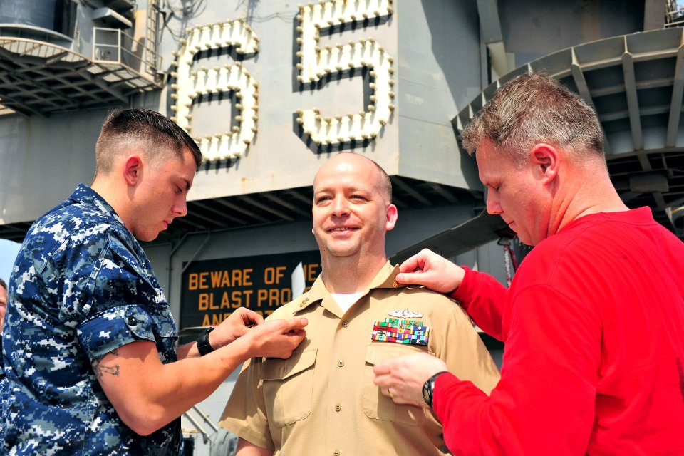 US Navy 110520-N-0074G-005 Master Chief Gunner's Mate Joseph A. Cassista is pinned with his master chief anchors during an awards ceremony on the f