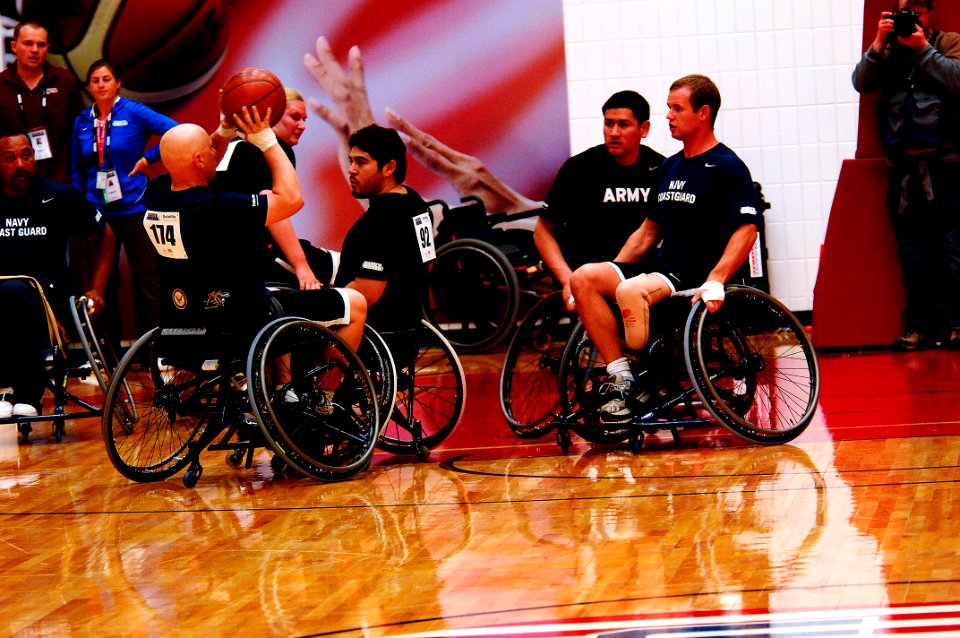 US Navy 110519-N-CD297-046 Logistics Specialist 1st Class Robert Lipscomb takes a shot against the Army Team in a preliminary game of wheelchair ba