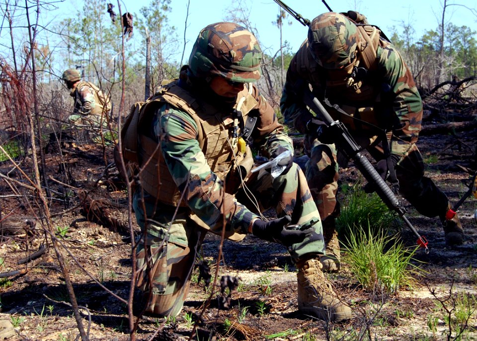 US Navy 110518-N-SD610-007 hief Builder Juan Campos uses a magnetic compass to verify his patrol's position during an officers and chiefs field tra