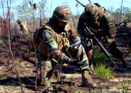 US Navy 110518-N-SD610-007 hief Builder Juan Campos uses a magnetic compass to verify his patrol's position during an officers and chiefs field tra