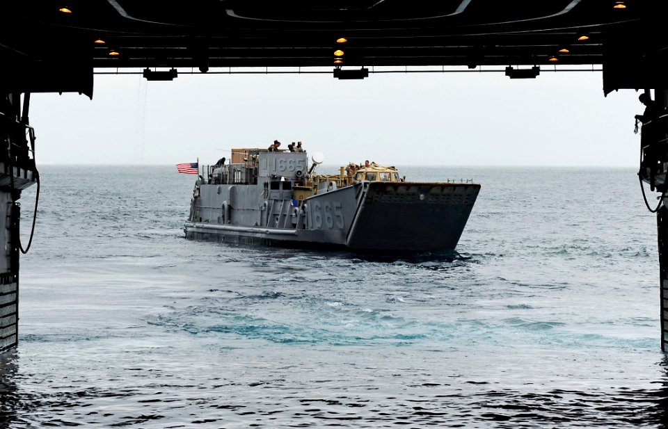 US Navy 110519-F-HS649-055 Landing Craft Utility (LCU) 1665 exits the well deck of the amphibious transport dock ship USS Cleveland (LPD 7) during