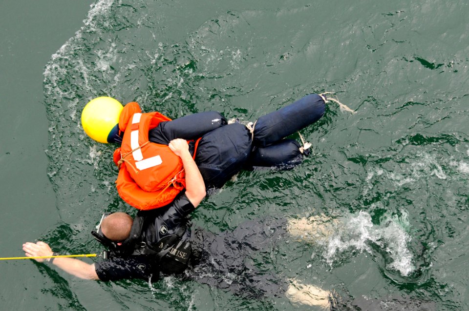 US Navy 110517-N-ER662-457 Search and rescue swimmer Seaman Matthew Honan recovers Oscar during a man overboard drill aboard USS Fitzgerald (DDG 62