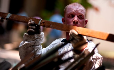 US Navy 110517-N-TU221-452 Hospital Corpsman 3rd Class Jonathan Martin removes pieces of wood from Hospicio De San Jose Orphanage during a communit