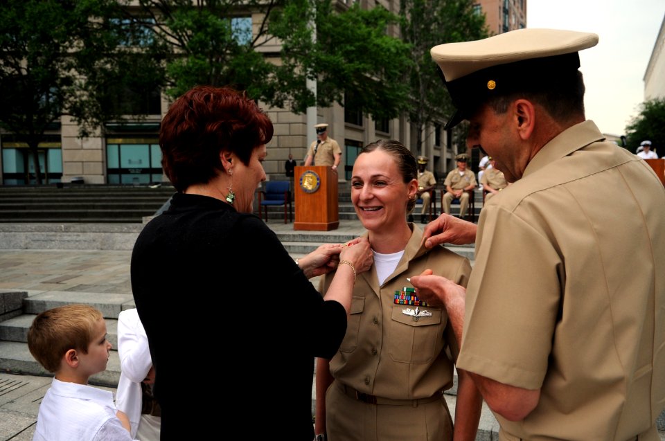 US Navy 110519-N-AD372-373 Chief Aircrew Survival Equipmentman Amy Davis, U.S. Fleet Forces Sailor of the Year, receives her chief's anchors from f