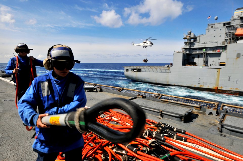 US Navy 110519-N-AG285-257 Sailors aboard the amphibious dock landing ship USS Whidbey Island (LSD 41) carry a cargo net hooking pole on the ship's