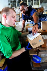 US Navy 110519-N-1004S-135 Logistics Specialist 2nd Class Tarence Pauldon, from Bronx, N.Y., shows Logistics Specialist Seaman Recruit Robert Vaugn