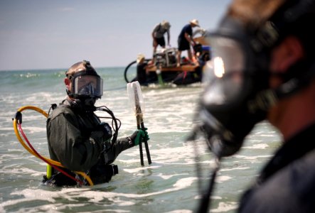 US Navy 110520-N-VF350-332 Chief Navy Diver Jason Shafer, left, and Navy Diver 2nd Class James Maxey prepare for an underwater dive during a Joint