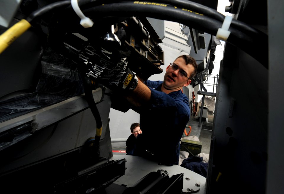 US Navy 110518-N-TB177-241 Fire Controlman 2nd Class Christopher J. Matranga assembles a 25 mm chain gun during maintenance aboard USS Truxtun (DDG
