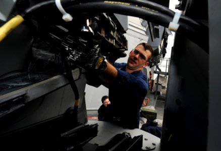 US Navy 110518-N-TB177-241 Fire Controlman 2nd Class Christopher J. Matranga assembles a 25 mm chain gun during maintenance aboard USS Truxtun (DDG