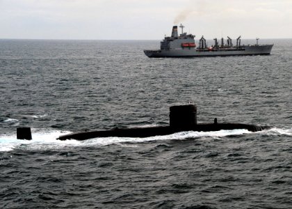 US Navy 110520-N-VQ827-895 The Royal Navy Trafalgar-class submarine HMS Torbay (S90) is underway in formation with the Military Sealift Command fle