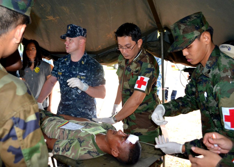 US Navy 110518-N-VA590-244 Senior Chief Hospital Corpsman Tom Gilham, center left, assigned to Commander, Task Force 73, reviews triage procedures