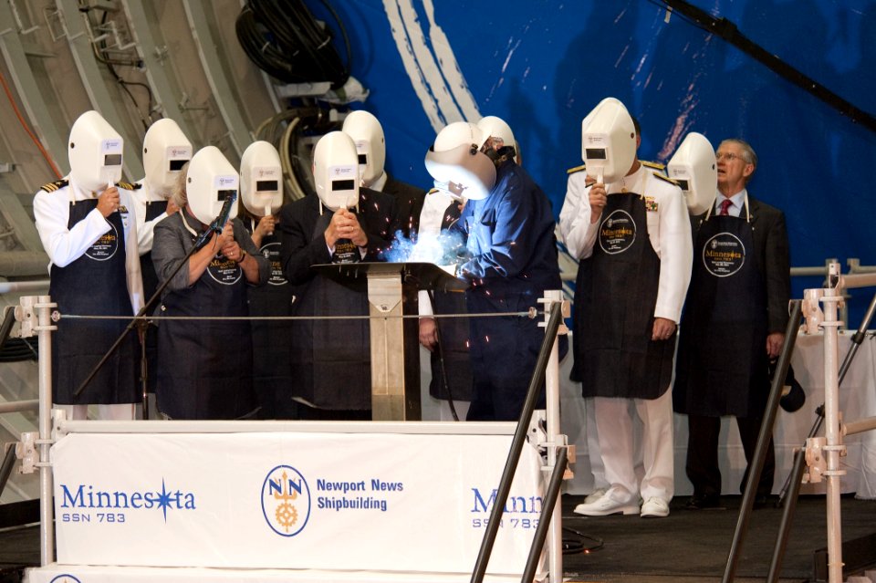 US Navy 110520-N-NC292-200 A welder inscribes the initials of ship's sponsor Ellen Roughead during the keel laying ceremony for the Virginia-class