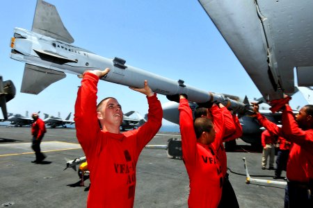 US Navy 110520-N-1004S-449 Sailors attach an Aim-9x Sidewinder missile to an F-A-18C Hornet aboard the aircraft carrier Ronald Reagan (CVN 76)