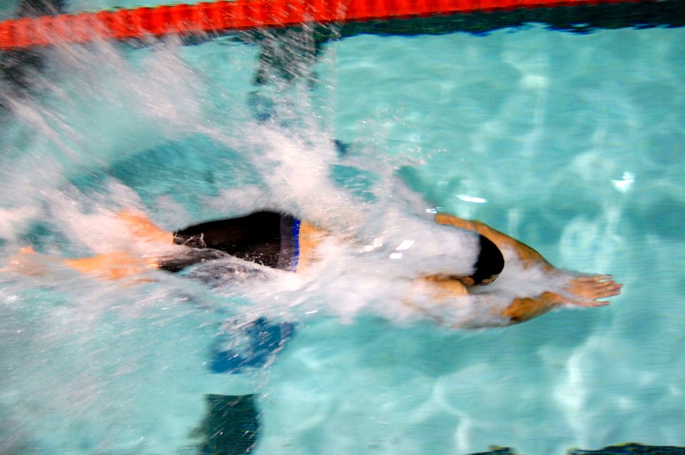 US Navy 110520-N-CD297-049 Explosive Ordnance Disposal 1st Class Patrick Woodruff dives into the pool at the start of the 50-meter Freestyle event
