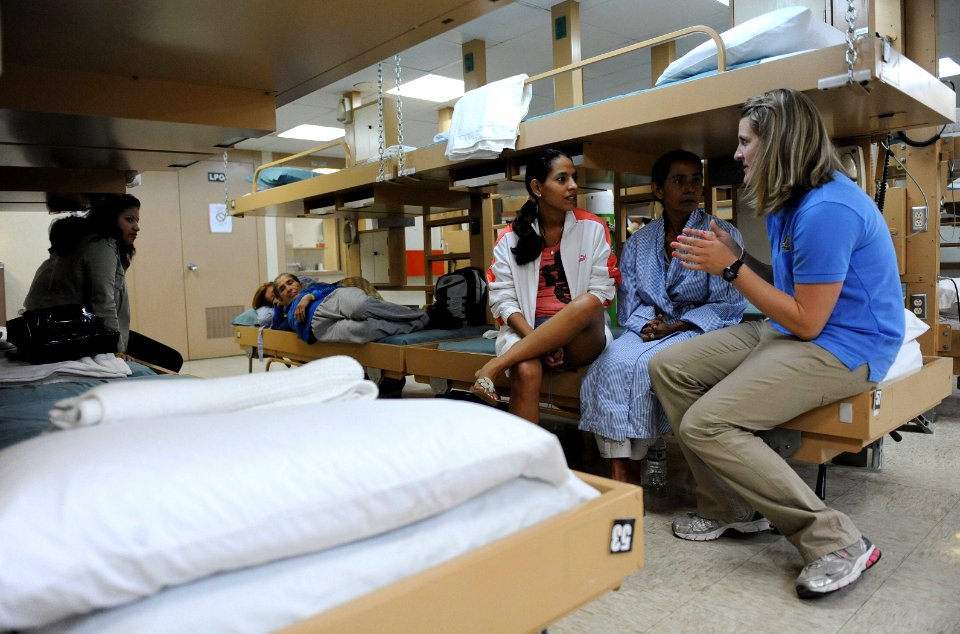 US Navy 110524-F-ET173-071 Latter-day Saints Charities registered nurse Kacie Egbert talks with patients before surgery aboard USNS Comfort (T-AH 2