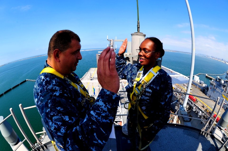 US Navy 110520-N-KD852-017 Lt. Cmdr. Antonio Ochoa reenlists Electronics Technician 2nd Class Justine Pennel for six more years from the top of the