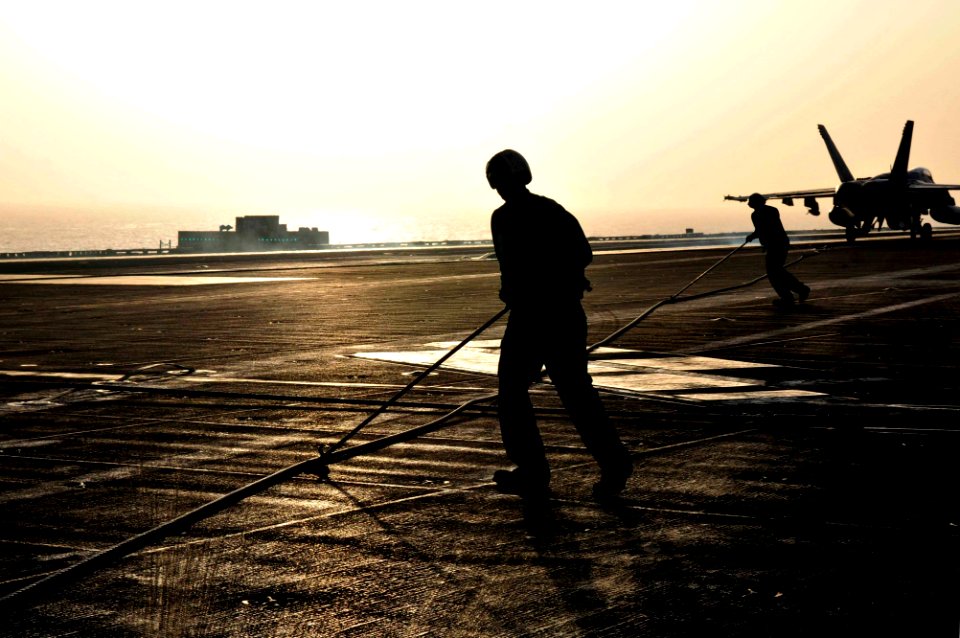 US Navy 110519-N-DM338-485 Sailors retract an arresting gear wire after an F-A-18E Super Hornet makes an arrested landing aboard the aircraft carri