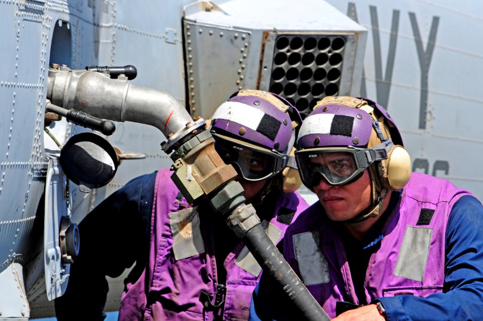 US Navy 110520-N-RC734-207 Engineman 3rd Class Sisco Elekana, right, and Engineman Fireman Emmanuel Robinson refuel a MH-60S Sea Hawk helicopter