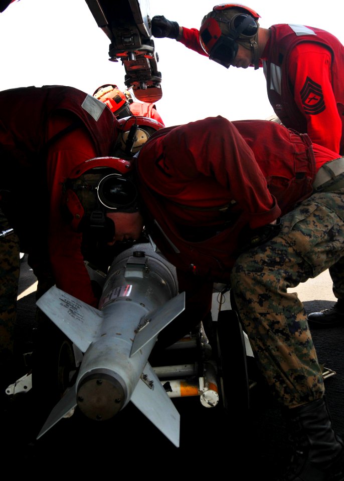US Navy 110521-N-GL340-136 Marines assigned to the Death Rattlers of Marine Fighter Attack Squadron (VMFA) 146 prepare to load ordnance onto an F-A