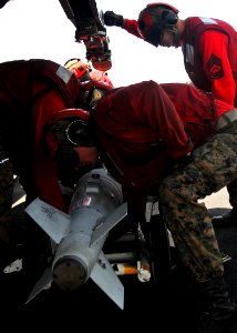 US Navy 110521-N-GL340-136 Marines assigned to the Death Rattlers of Marine Fighter Attack Squadron (VMFA) 146 prepare to load ordnance onto an F-A