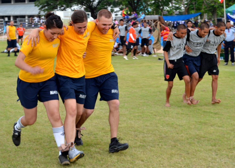 US Navy 110519-N-VA590-457 Sailors participate in the three-person, four-legged race during Sports Day at Nong Prue Municipality Sports Field