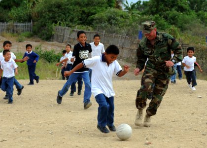 US Navy 110524-N-NY820-476 Senior Chief Master-at-Arms Gerald Rainford plays soccer at a school in Manta, Ecuador, during a community service event