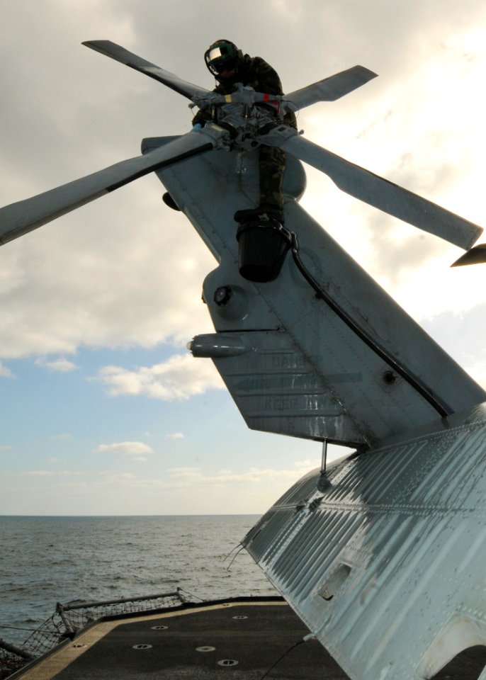 US Navy 110519-N-YM590-022 Aviation Electronics Technician 3rd Class Anthony Ocasioalmodovar washes the tail section of an SH-60B Sea Hawk helicopt