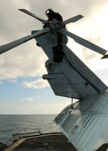 US Navy 110519-N-YM590-022 Aviation Electronics Technician 3rd Class Anthony Ocasioalmodovar washes the tail section of an SH-60B Sea Hawk helicopt