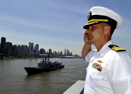 US Navy 110525-N-2147L-001 Cmdr. William Herrmann renders honors to USS Carr (FFG 52) during a parade of ships in the New York Harbor