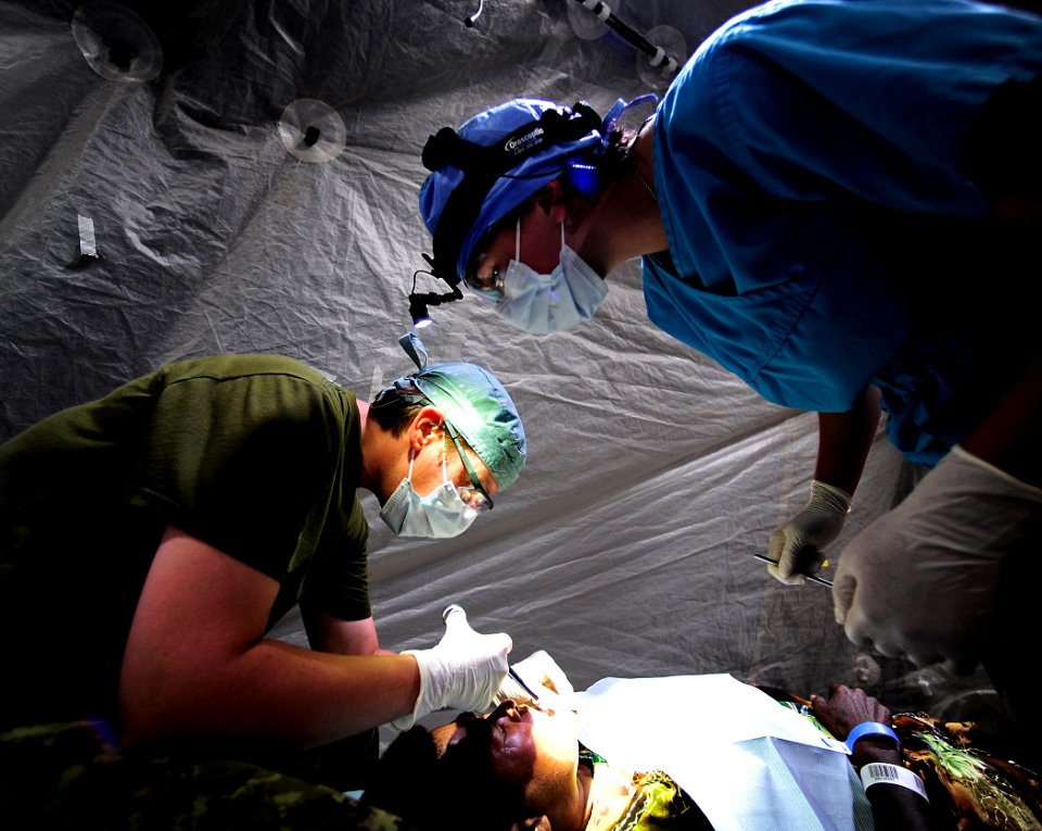 US Navy 110523-F-HS649-100 Canadian Army Cpl. dental technician Tracy Faught administers anesthesia as Royal Australian Navy dentist Lt. Shannon Go