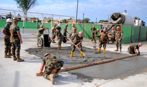 US Navy 110520-N-AW868-001 Seabees assigned to Naval Mobile Construction Battalion (NMCB) 74, Detachment Senegal, pour concrete for a pool project