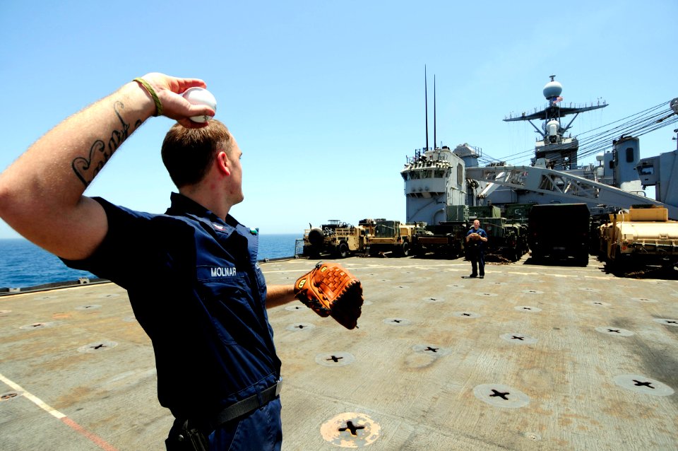US Navy 110520-N-RC734-110 Electrician's Mate 3rd Class Ciejay Molnar plays catch with Electrician's Mate 3rd Class Scott Grant on the flight deck