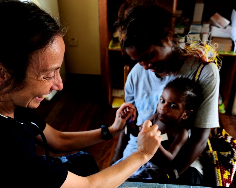 US Navy 110523-F-HS649-128 Pediatric nurse Lt. Cmdr. Rivka Weiss plays with a Papua New Guinean baby during a Pacific Partnership 2011 medical civi