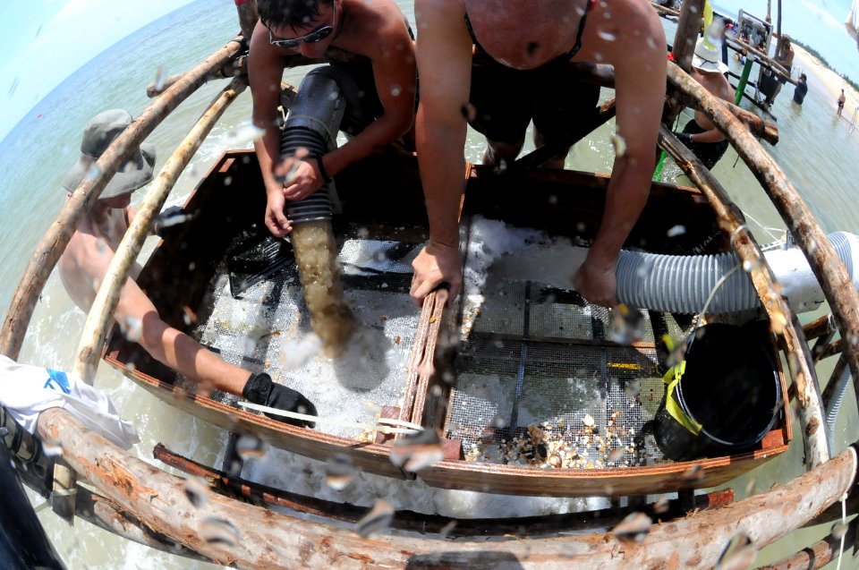 US Navy 110521-N-VF350-057 Personnel assigned to the Joint POW-MIA Accounting Command screen sediment retrieved from the ocean floor for human rema