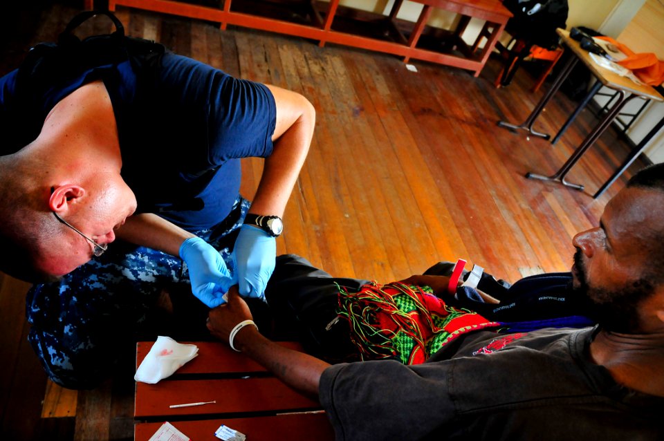 US Navy 110524-O-ZZ999-012 Hospital Corpsman 2nd Class Alan Kampert gives a Papua New Guinean man a malaria test during a Pacific Partnership 2011