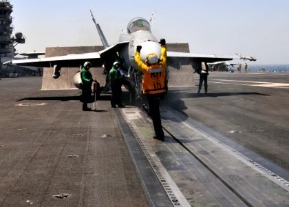 US Navy 110521-N-GL340-128 Aviation Boatswain's Mate (Handling) 1st Class Christina Duvall, from San Diego, guides an F-A-18C Hornet assigned to th