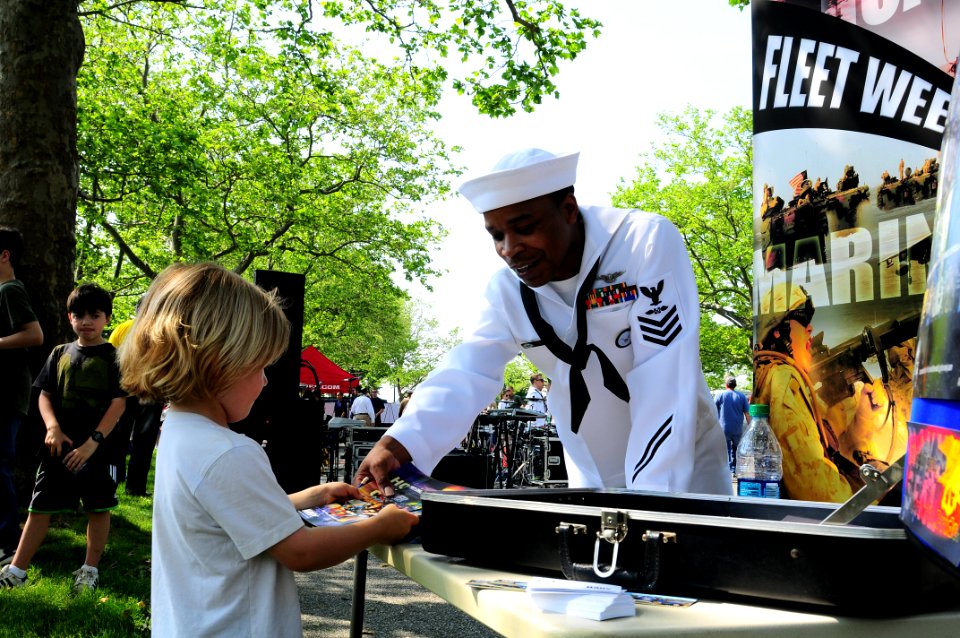 US Navy 110528-N-YM084-065 Aviation Boatswain's Mate (Fuel) 1st Class Colin Louis talks to a boy about the U.S Navy during the Fleet Week Air and G