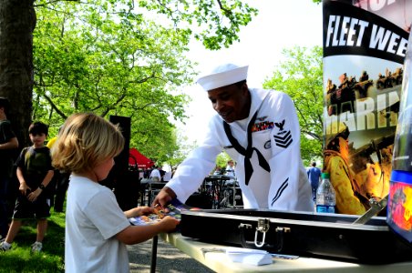 US Navy 110528-N-YM084-065 Aviation Boatswain's Mate (Fuel) 1st Class Colin Louis talks to a boy about the U.S Navy during the Fleet Week Air and G
