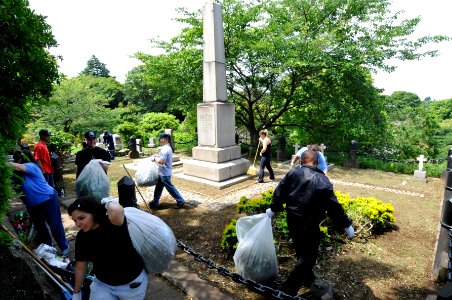 US Navy 110525-N-MU720-033 Sailors and volunteers clean up a monument dedicated to U.S. Navy and Marines during a cleanup project at the Yokohama F