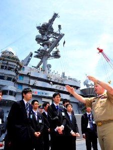 US Navy 110525-N-MH885-033 Lt. Cmdr. Dave Hecht explains how the catapult system operates to members of the Japan Ministry of Defense during a tour